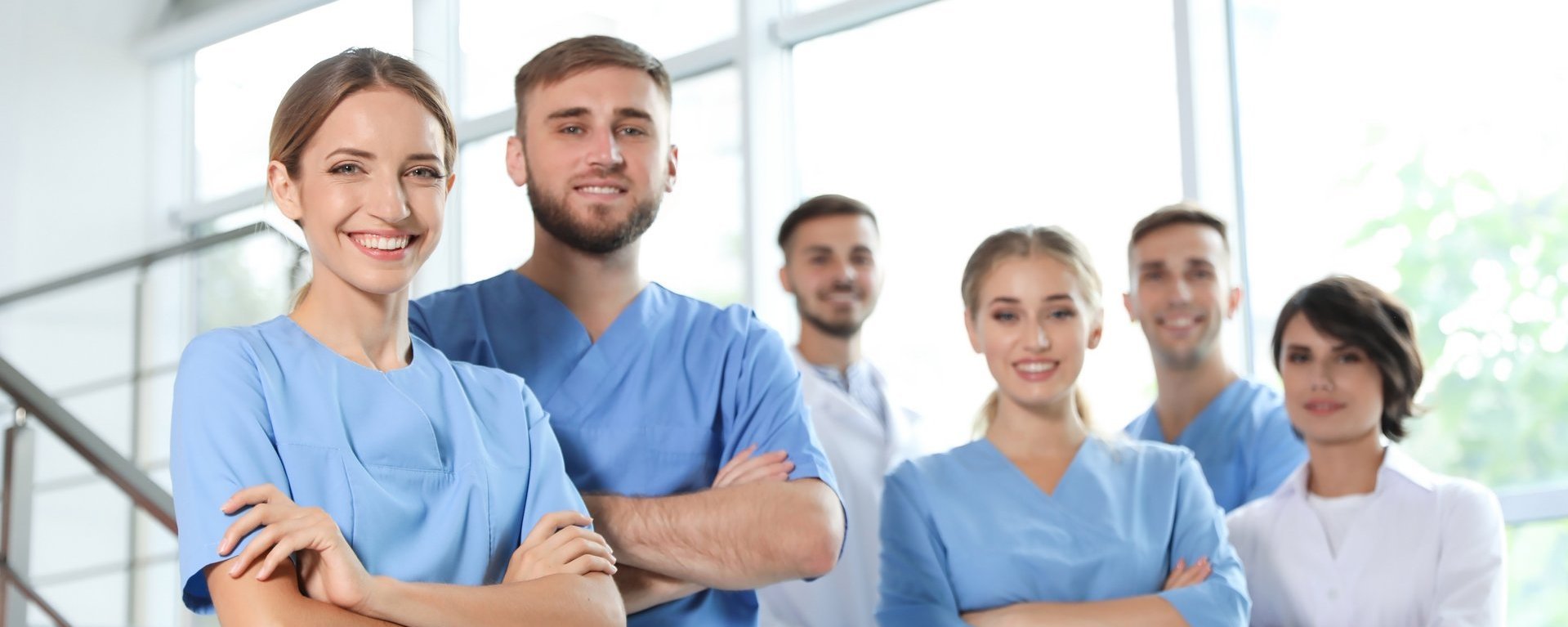 Junges Pflegeteam posiert selbstbewusst im Krankenhaus